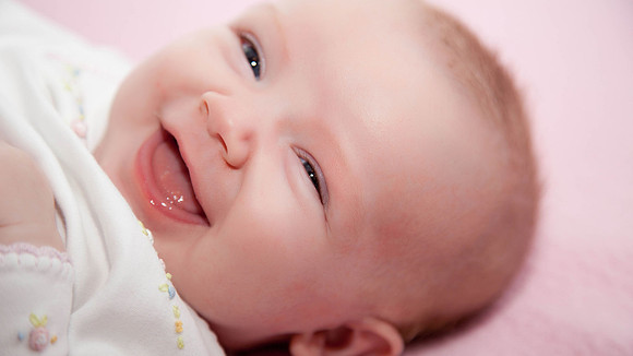 Laughing Baby on Bed