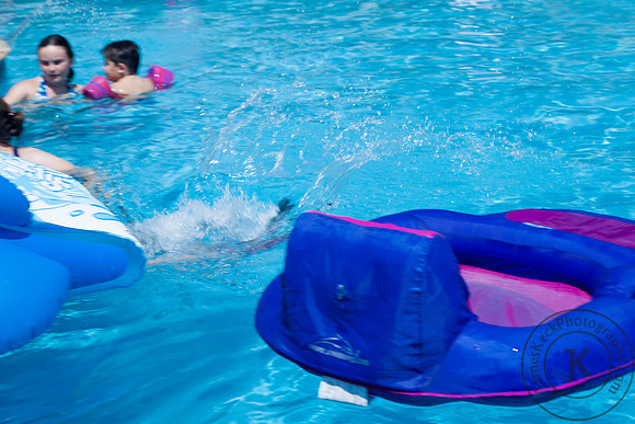 Little Girl Splashing Into the Pool