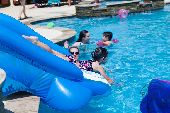 Little Girl Sliding Down a Water Slide