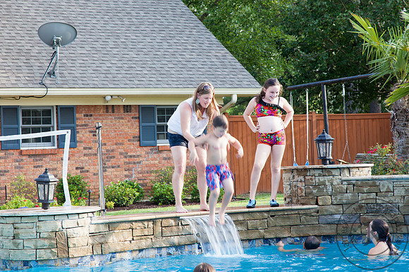 Woman Throwing Boy into the Pool