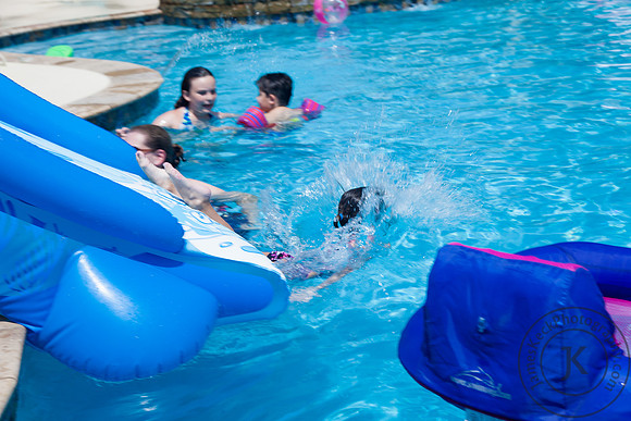 Little Girl Splashing Into the Pool