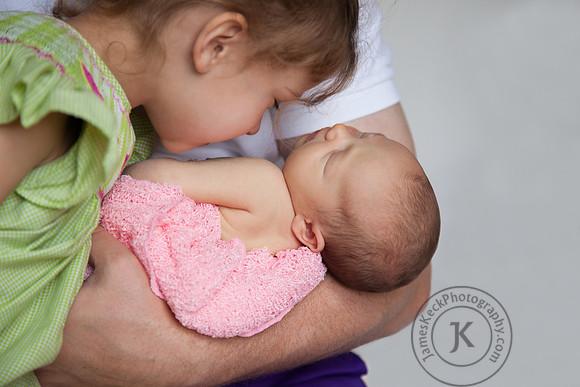 Emmy and Baby Georgia Held in Daddy's Arms