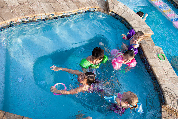 Group of Children Swimming in Pool