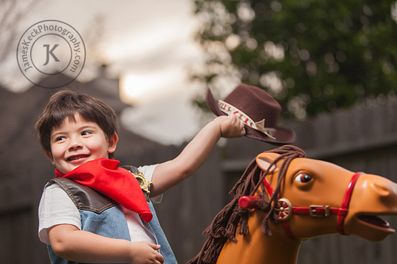 Portrait of Boy Dressed as a Cowboy Riding a Toy Horse