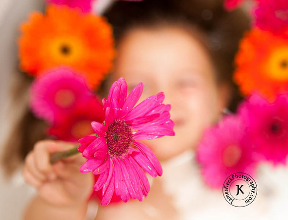 Portrait of Girl Holding Gerbera Daisy in Bathtub