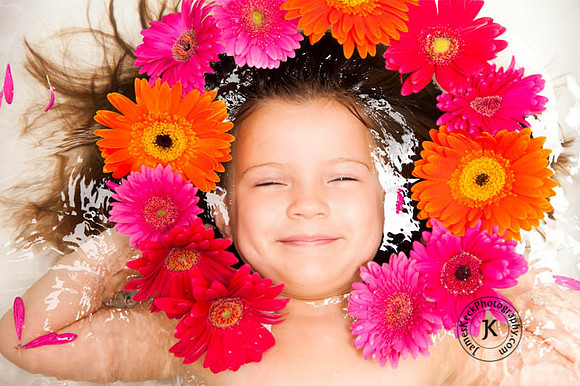 Portrait of Girl with Gerbera Daisies in Bathtub