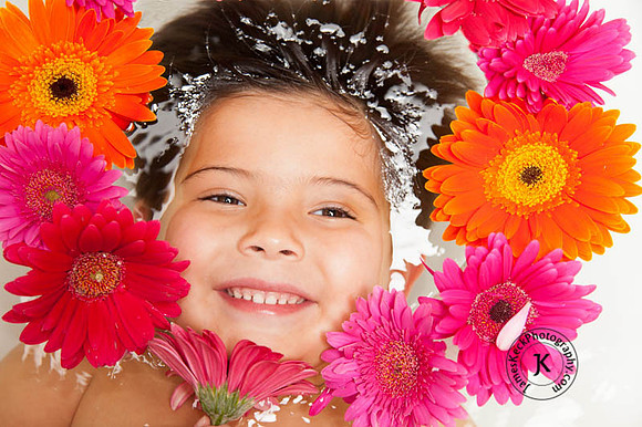 Portrait of Smiling Boy with Gerbera Daisies in Bathtub