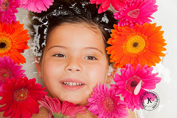 Portrait of Boy with Gerbera Daisies in Bathtub
