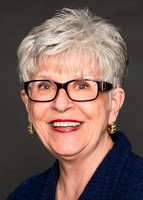 Professional Executive Assistant LinkedIn Headshot - woman in blue shirt
