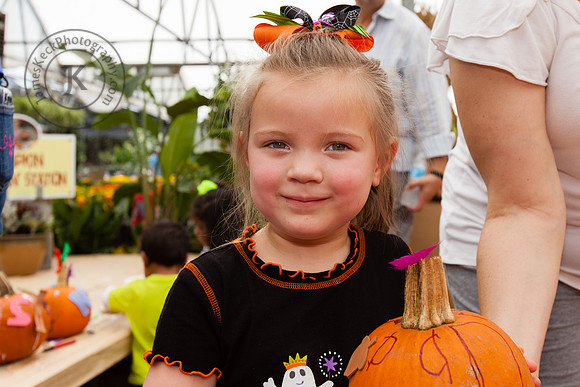 Portrait of Girl Holding Up Pumpkin