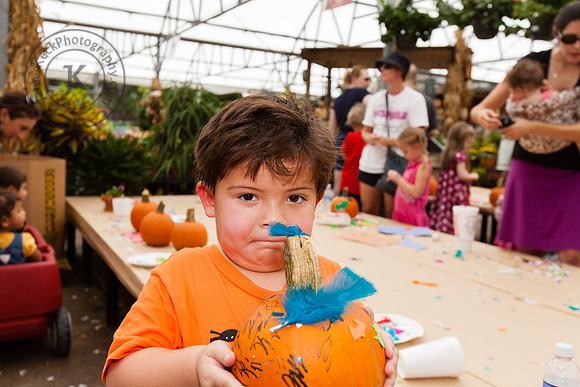 Portrait of Boy Holding Up Pumpkin