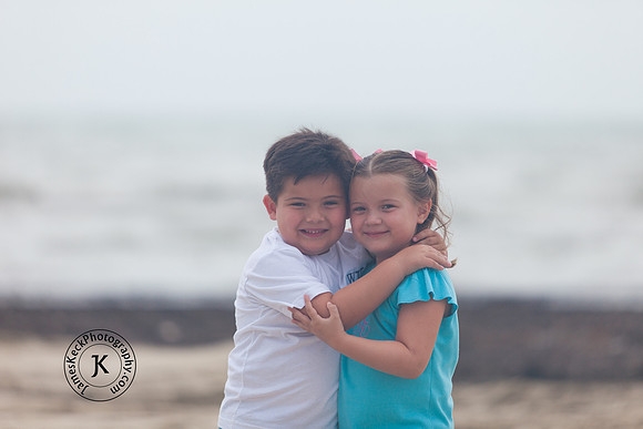 Portrait of Brother and Sister Hugging on the Beach