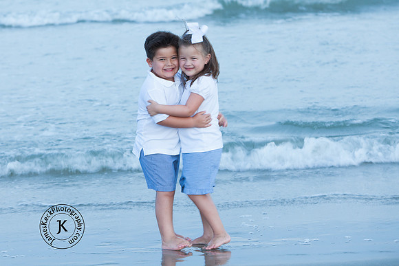 Portrait of Brother and Sister Hugging on the Beach
