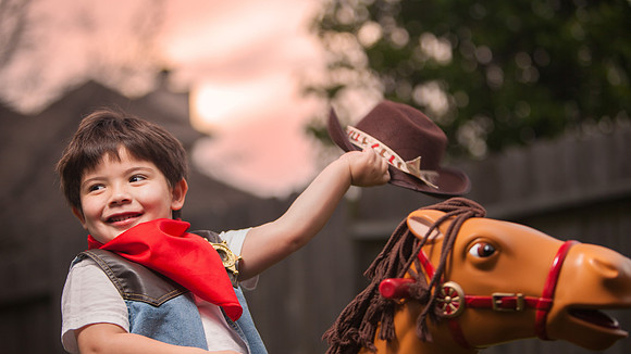 Boy Dresses as Cowboy with Toy Horse