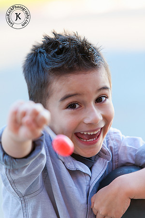 Smiling Boy Portrait with a Lollipop