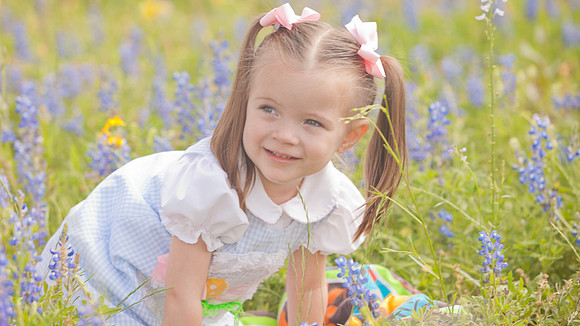 Girl Playing in the Wildflowers Portrait